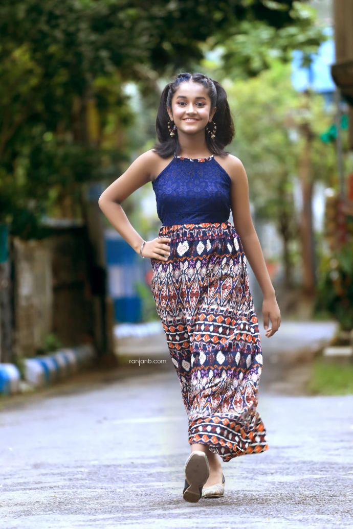 Ridhi Rajak walking confidently during an outdoor fashion photoshoot, showcasing her talent as a kid fashion model and child artist in a stylish full-length portrait.