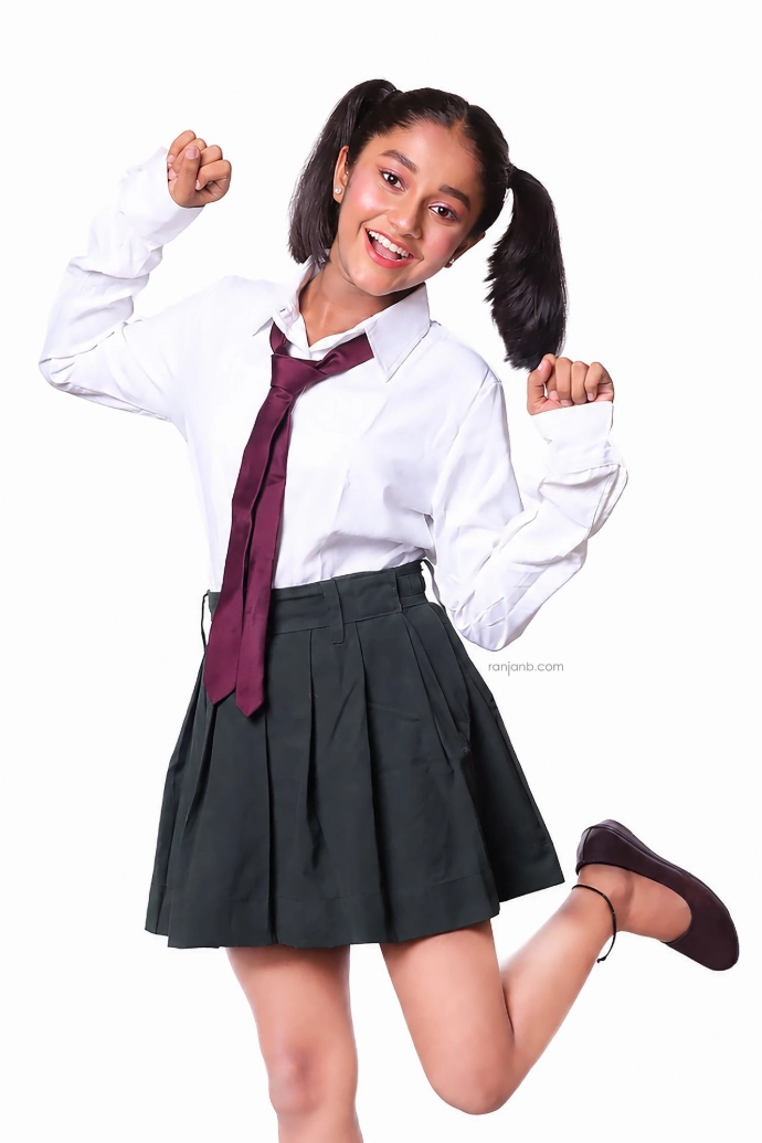 Ridhi Rajak posing in a stylish school uniform during a professional studio fashion photoshoot, showcasing confidence as a kid fashion model and child artist.