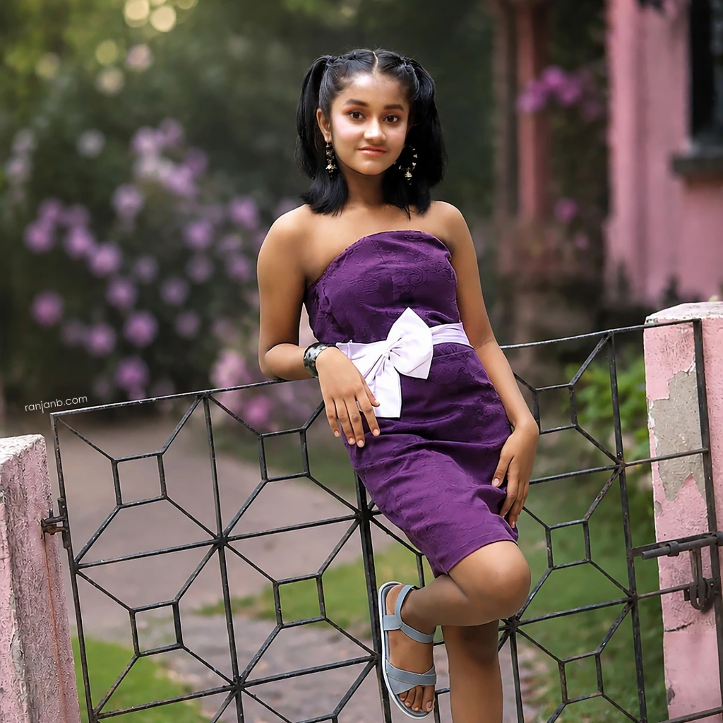 Ridhi Rajak posing for a professional kids fashion campaign in a purple designer dress